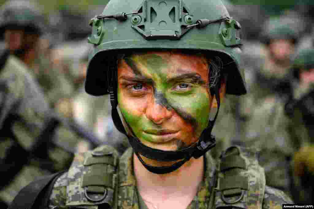 A Kosovar soldier poses for a photograph after taking part in a U.S.-led multinational exercise in the village of Deva, Kosovo, on May 28.