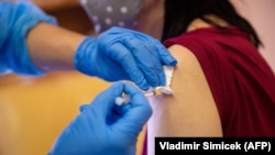 A woman receives the first dose of the Sputnik V vaccine against COVID-19 in Bratislava on June 7.