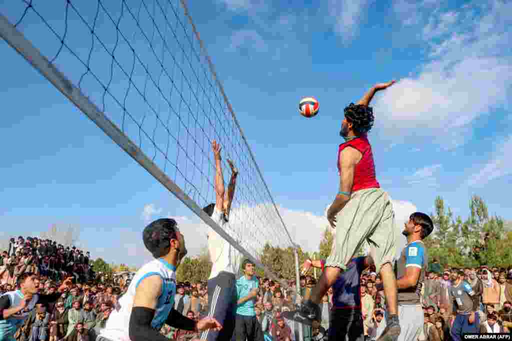 Afghan youth compete in a volleyball match during a tournament at a field in the Argo district of Badakhshan Province.