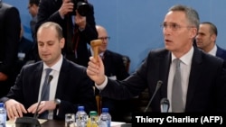 NATO Secretary-General Jens Stoltenberg (right) and Georgian Foreign Minister Mikheil Janelidze attend a NATO foreign ministers' meeting held at NATO headquarter in Brussels on December 6.