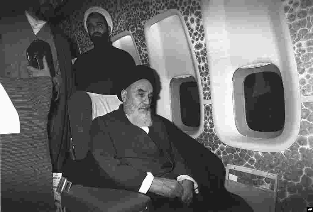 Khomeini sits inside the chartered airplane which was to fly him back to Iran.