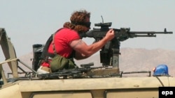 A U.S. DynCorp security company employee secures the area around the Provincial Reconstruction Team PRT facilities in Herat. (file photo)