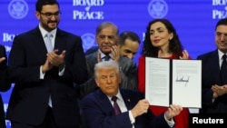 US President Donald Trump holds a signed charter of the Board of Peace at the World Economic Forum in Davos, Switzerland, on January 22. 