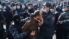 A man is taken away by law enforcement officers during an opposition rally to demand the resignation of Armenian Prime Minister Nikol Pashinian 