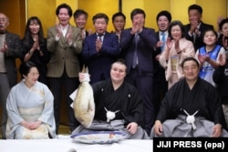 Yavhusishyn holds a seabream fish after winning the Kyushi Grand Sumo Tournament in November 2025.