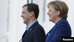 Seeing eye-to-eye? German Chancellor Angela Merkel (right) and Russian President Dmitry Medvedev at the government guest house, Schloss Meseberg, north of Berlin