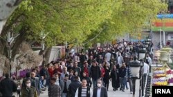 This recent undated photo from Iran shows few people are wearing masks.