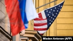 A Russian flag flies next to the U.S. Embassy in Moscow (file photo)