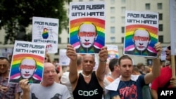 Protesters holding anti-Vladimir Putin posters march past the British prime minister's residence on Downing Street in central London on August 10.