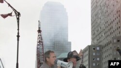 U.S. President George W. Bush speaks to firefighters at Ground Zero on September 14, 2001.