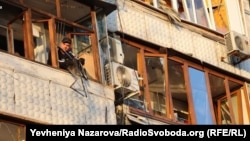 A man looks out from a damaged residential building following the Russian attack on Zaporizhzhya.