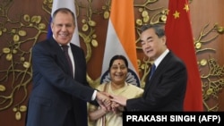 Russian Foreign Minister Sergey Lavrov (L), Indian External Affairs Minister Sushma Swaraj (C), and Chinese Foreign Minister Wang Yi pose for a photograph ahead of a trilateral meeting in New Delhi on December 11. 