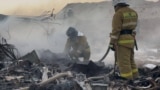 Kazakh emergency specialists work at the crash site of an Azerbaijani passenger jet that crashed in the western city of Aqtau on December 25, killing dozens.