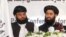 Muhammad Naeem (right), a spokesman for the Office of the Taliban of Afghanistan, speaks during the opening of the Taliban Afghanistan Political Office in Doha on June 18.