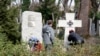 The now-removed plaque (left) is seen on March 18 next to a memorial in Prague's Olsany Cemetery that honors White Army veteran emigres who were defeated by the Bolshevik Red Army.