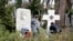 The now-removed plaque (left) is seen on March 18 next to a memorial in Prague's Olsany Cemetery that honors White Army veteran emigres who were defeated by the Bolshevik Red Army.