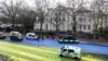 The campaign group Led By Donkeys halted traffic before spreading more than 300 liters of paint across the road using wheelbarrows and brushes to make the 500-square-meter (5,382-square-foot) flag outside the Russian Embassy in London on February 23.