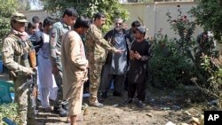 Security forces investigate an explosion that killed Abdul Jabar Qahraman, a candidate in parliamentary elections, at his home in Lashkar Gah, the capital of the southern Helmand Province, on October 17, 2018.