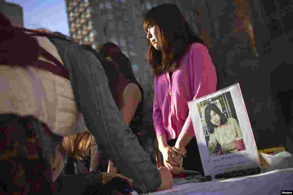 A photo of Boston Marathon bombing victim Lu Lingzi, a Boston University graduate student and Chinese citizen, is seen outside the Boston University Marsh Chapel before her memorial service in Boston, Massachusetts, on April 17, 2013.