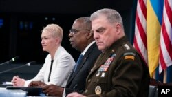 Secretary of Defense Lloyd Austin (center), Chairman of the Joint Chiefs General Mark Milley (right) and Assistant Secretary of Defense for International Security Affairs Celeste Wallander (left) attend during a virtual meeting of the Ukraine Defense Contact Group at the Pentagon in Washington on July 18.