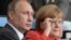 Пуцін і Мэркель глядзяць футбол