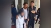 Azerbaijan - a girl is escorted out of her school in Jalilabad, Azerbaijan, during a dispute over a ban on hijabs in school - screen grab