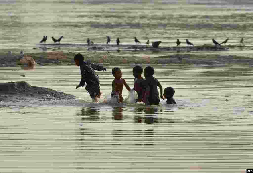 Pakistani children play in the Ravi River in Lahore as the country finds itself in the midst of a heatwave. (AFP/Arif Ali)