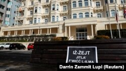 A placard with a Maltese idiom that roughly translates as "The truth will always out" is seen outside the headquarters of the Maltese-registered Pilatus Bank in the town of Ta' Xbiex. The bank's director, Ali Sadr Hashemi Nejad, was arrested in the United States on March 19 on charges of evading U.S. sanctions on Iran.