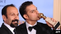 Director Asghar Farhadi (left) and actor and screenwriter Peyman Moaadi pose with their Golden Globe for best foreign language film.
