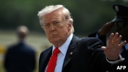 US President Donald Trump waves after his arrival at Ocala International Airport, in Ocala, Florida on May 1, 2026.