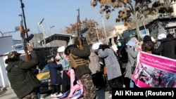 Taliban fighters fire shots in the air to disperse women protesters in Kabul.