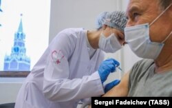 A Russian health worker administers a vaccine shot in Moscow.