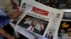 A man takes a glance at a newspaper with a picture of U.S. president Donald Trump on the front page, in the capital Tehran. The headline on photo says "Meeting with Rouhani without preconditions." July 31, 2018