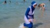 RELIGION-BURQA/FRANCE/A woman wearing a burkini walks in the water August 27, 2016 on a beach in Marseille, France, the day after the country's highest administrative court suspended a ban on full-body burkini swimsuits that has outraged Muslims and opene
