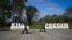 Russian guards walk past signs that read "DPRK" (Democratic People's Republic of Korea) and "Russia" at the border crossing between Russia and North Korea.
