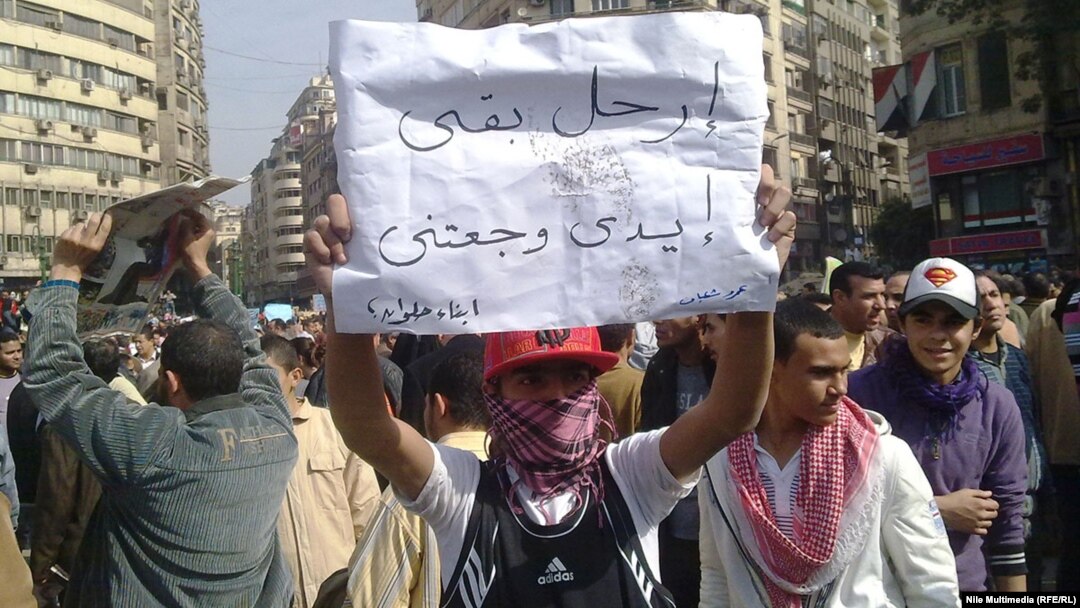 A young protester during the antigovernment demonstrations in Cairo's Tahrir Square in February 2011: "Enough already, my arms hurt!"