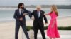Britain's Prime Minister Boris Johnson, his spouse Carrie Johnson and Canada's Prime Minister Justin Trudeau bump elbows during the G7 summit in Carbis Bay, Cornwall