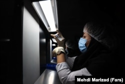 A medical technician works on the production line of Iran's COVIran Barekat vaccine.