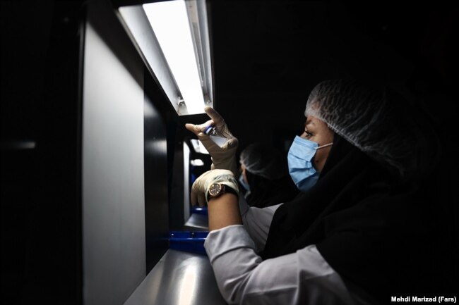 A medical technician works on the production line of Iran's COVIran Barekat vaccine.