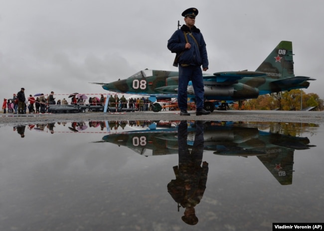 A Russian soldier patrols at Kant, a Russian air base outside Bishkek.