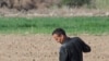 Uzbek farmers work in the field in spring in Karakalpakstan, Uzbekistan, Central Asia - April 2019
