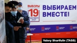 Law enforcement officers observing polling station No. 144 in Moscow.