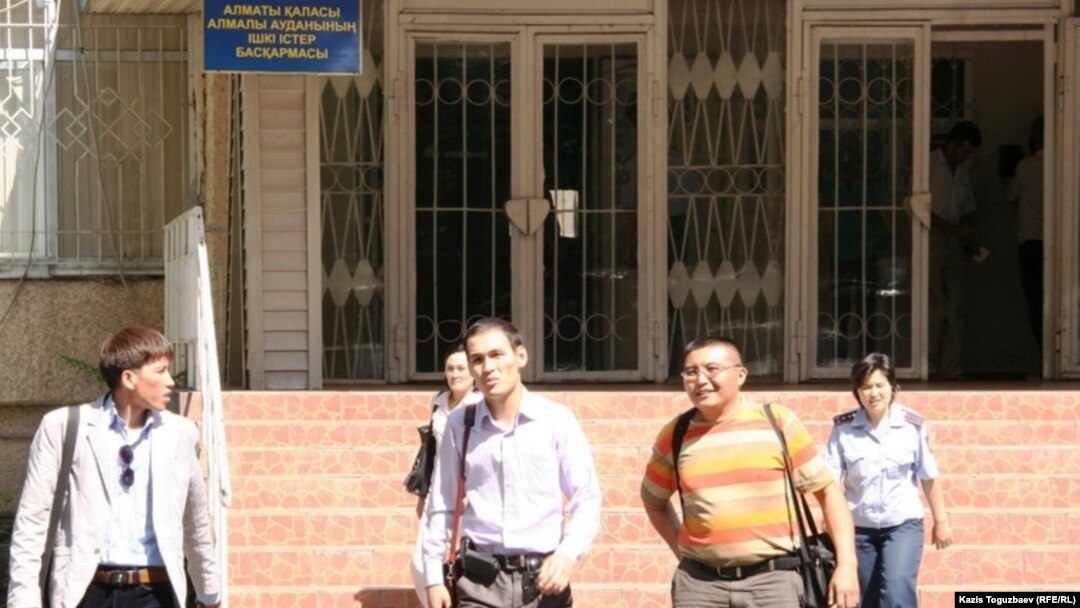 Detained journalists leave the Almaly district police station.