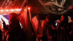 People chant slogans at a rally on Enghelab Square in Tehran on April 13 against the US-Israeli war with Iran.