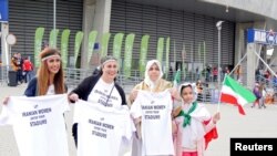 Women hold t-shirts as they protest for Iranian women's rights to enter stadiums in Iran, ahead of the FIVB Volleyball World League