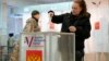 A woman casts her ballot at a polling station in St. Petersburg on March 15.