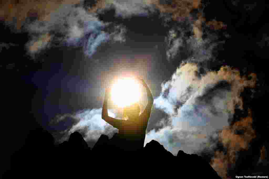 A person celebrates the summer solstice at the Kokino megalithic observatory near the city of Kumanovo in North Macedonia on June 21.&nbsp;