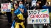 A woman, her baby swaddled in a Ukrainian flag, joined a protest in Hong Kong on March 24 to mark one month since Russia's invasion of Ukraine.