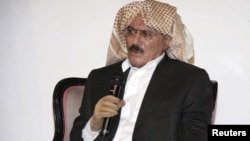 His hands and head covered to hide his injuries, President Ali Abdullah Saleh speaks during a meeting with players of the national soccer team in Sanaa on September 25.