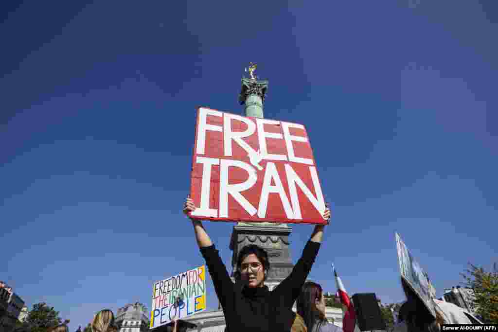 A protester holds a placard during a march in Paris marking the second anniversary of a protest movement sparked by the death in custody of Kurdish-Iranian student Mahsa Amini.